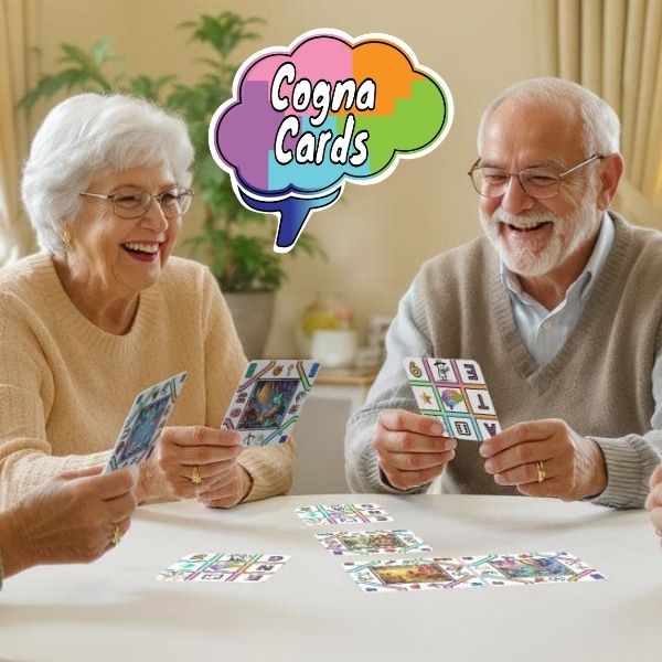 A cheerful group of senior adults sitting around a table in a care home, laughing and playing with CognaCards—square white game cards featuring symbols and story scenes—during a mentally stimulating group activity